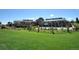 Beautiful community clubhouse with a spacious lawn, perfect for outdoor gatherings at 7852 S Addison Way, Aurora, CO 80016