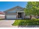 Charming home featuring manicured lawn, covered porch, and attached two-car garage at 7852 S Addison Way, Aurora, CO 80016