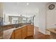 Open kitchen with stainless steel appliances, granite counters, and hardwood floors at 7852 S Addison Way, Aurora, CO 80016