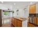 Open kitchen with stainless steel appliances, granite counters, and hardwood floors at 7852 S Addison Way, Aurora, CO 80016