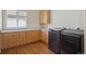 Well-equipped laundry room with modern appliances, ample counter space, and wood cabinets at 7852 S Addison Way, Aurora, CO 80016