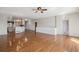Spacious open-concept living room with gleaming hardwood floors and plenty of natural light at 7852 S Addison Way, Aurora, CO 80016