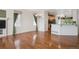 Spacious open-concept living room with gleaming hardwood floors and plenty of natural light at 7852 S Addison Way, Aurora, CO 80016