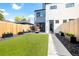 This modern backyard is complete with artificial turf, a stone walkway, potted plants, and a patio set at 2321 S Acoma St, Denver, CO 80223