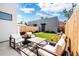 Inviting backyard featuring lush artificial turf, elegant patio furniture, and a modern accessory building at 2321 S Acoma St, Denver, CO 80223