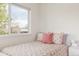 Bright bedroom with floral bedding, side table, closet, and natural light at 2321 S Acoma St, Denver, CO 80223
