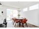 Sunlit dining area featuring modern chairs, a wooden table, and access to outdoor space at 2321 S Acoma St, Denver, CO 80223