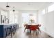 Bright dining area adjacent to kitchen featuring stylish pendant lights and access to backyard at 2321 S Acoma St, Denver, CO 80223
