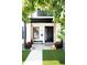 Charming porch featuring a black door, modern planters, and decorative pumpkins creating inviting curb appeal at 2321 S Acoma St, Denver, CO 80223