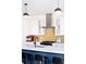 Modern kitchen with stainless steel appliances, a striking yellow tile backsplash, and stylish pendant lighting at 2321 S Acoma St, Denver, CO 80223