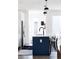 Modern kitchen island featuring black pendant lights, bar stool seating, and a sleek black faucet at 2321 S Acoma St, Denver, CO 80223