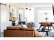 Bright open-concept living space with modern furnishings, kitchen island, and a dining area at 2321 S Acoma St, Denver, CO 80223
