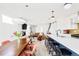 Open-concept living space featuring a modern fireplace, a leather couch, a kitchen island and a dining table at 2321 S Acoma St, Denver, CO 80223