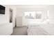 Bright bedroom featuring ample natural light, white walls, closet, and modern furnishings at 2321 S Acoma St, Denver, CO 80223
