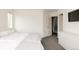 A minimalist white bedroom featuring grey carpet, closet, and a contemporary design at 2321 S Acoma St, Denver, CO 80223
