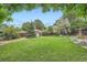 The expansive backyard features lush green grass, mature trees, and a charming storage shed at 7491 W 45Th Ave, Wheat Ridge, CO 80033