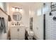 This bathroom features a stylish vanity and a modern glass-enclosed shower with sleek black and white tiling at 7491 W 45Th Ave, Wheat Ridge, CO 80033