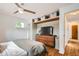 Cozy bedroom with hardwood floors, a wooden dresser, and overhead storage at 7491 W 45Th Ave, Wheat Ridge, CO 80033
