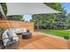 The wood patio includes ample seating around a modern fire pit and views of the sprawling green lawn at 7491 W 45Th Ave, Wheat Ridge, CO 80033