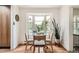 Cozy dining area featuring a bay window, hardwood floors, and seating for four at 7491 W 45Th Ave, Wheat Ridge, CO 80033