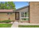 Home's entryway featuring a modern front door, large window, and a brick facade at 7491 W 45Th Ave, Wheat Ridge, CO 80033