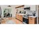 Modern kitchen with wood cabinetry, stainless steel appliances, and an open design for easy flow at 7491 W 45Th Ave, Wheat Ridge, CO 80033