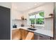 Well-lit kitchen featuring modern countertops, stainless steel dishwasher and sink under large window at 7491 W 45Th Ave, Wheat Ridge, CO 80033