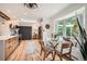 Open-concept kitchen and dining area featuring modern appliances, natural light, and wood cabinetry at 7491 W 45Th Ave, Wheat Ridge, CO 80033