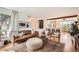 Open living area with a comfortable leather sofa, stylish rug, and breakfast bar at 7491 W 45Th Ave, Wheat Ridge, CO 80033
