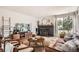 Cozy living room with fireplace, modern furnishings, and a large window at 7491 W 45Th Ave, Wheat Ridge, CO 80033