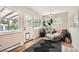 Sunlit mud room with ceramic tile flooring, plants, a cozy chair, and outdoor access at 7491 W 45Th Ave, Wheat Ridge, CO 80033