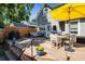 Spacious wooden deck with outdoor seating and a large yellow umbrella, perfect for entertaining at 3943 Newton St, Denver, CO 80211