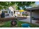 Landscaped backyard with a spacious deck, fire pit, and outdoor seating area at 3943 Newton St, Denver, CO 80211