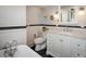 Elegant bathroom featuring white vanity, marble counters, and a classic clawfoot bathtub at 3943 Newton St, Denver, CO 80211
