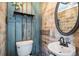 Charming powder room features unique wall treatments, a decorative mirror, and a pedestal sink at 3943 Newton St, Denver, CO 80211
