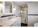 Stylish bathroom with a white vanity, granite countertop, and tiled walk-in shower at 3943 Newton St, Denver, CO 80211