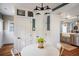 Cozy breakfast nook with white table and chairs adjacent to the open kitchen at 3943 Newton St, Denver, CO 80211