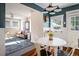 Bright dining area features stylish lighting, hardwood floors, and easy access to the living room at 3943 Newton St, Denver, CO 80211