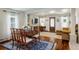 Open-concept dining room and living room boasts hardwood floors and stylish decor at 3943 Newton St, Denver, CO 80211