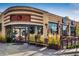 Modern brick building exterior with outdoor patio seating and large windows at 3943 Newton St, Denver, CO 80211