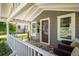 Charming front porch with seating, decorative rug, and well-maintained landscaping at 3943 Newton St, Denver, CO 80211