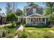 Charming gray two-story home with a manicured front yard, white picket fence, and inviting porch at 3943 Newton St, Denver, CO 80211