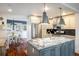 Well-lit kitchen with stainless steel appliances, granite countertops, and a view to the breakfast nook at 3943 Newton St, Denver, CO 80211