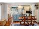 Open concept kitchen and dining area featuring a large island, stainless steel appliances, and wooden table at 3943 Newton St, Denver, CO 80211