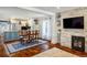 Bright interior showing a living and dining space with hardwood floors and a stone fireplace at 3943 Newton St, Denver, CO 80211