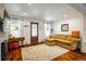 Inviting living room has hardwood floors, large windows, and a comfortable sectional sofa at 3943 Newton St, Denver, CO 80211