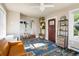 Living room showcases a decorative front door, ceiling fan, and patterned area rug at 3943 Newton St, Denver, CO 80211