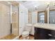 Bathroom featuring a glass shower and vanity with a marble countertop at 325 Clayton St, Denver, CO 80206