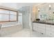 Bright bathroom featuring marble finishes, glass shower, and soaking tub at 325 Clayton St, Denver, CO 80206