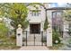 Elegant home featuring a gated front entrance with decorative columns and manicured landscaping at 325 Clayton St, Denver, CO 80206